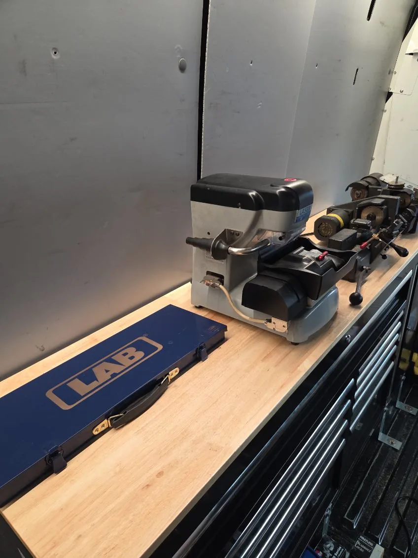 Locksmith key cutting equipment set up inside the service van