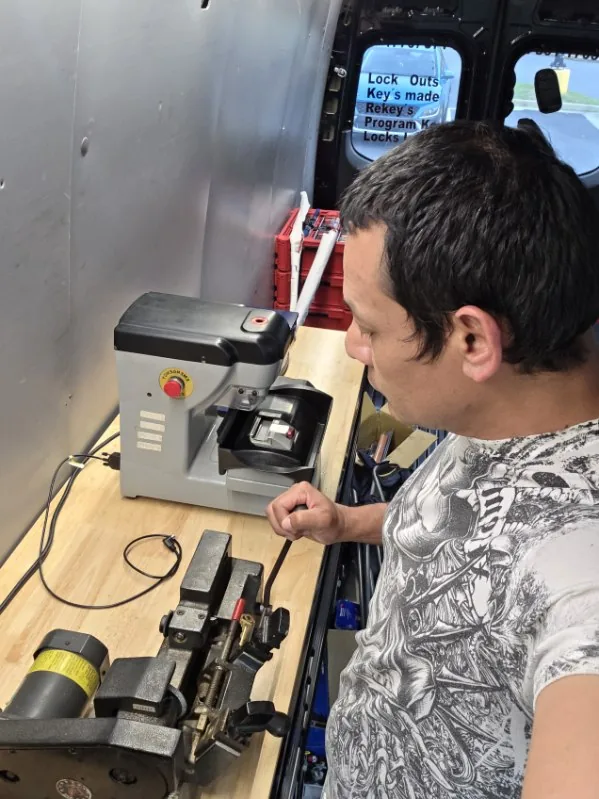 Active Safe and Lock technician working with key programming equipment