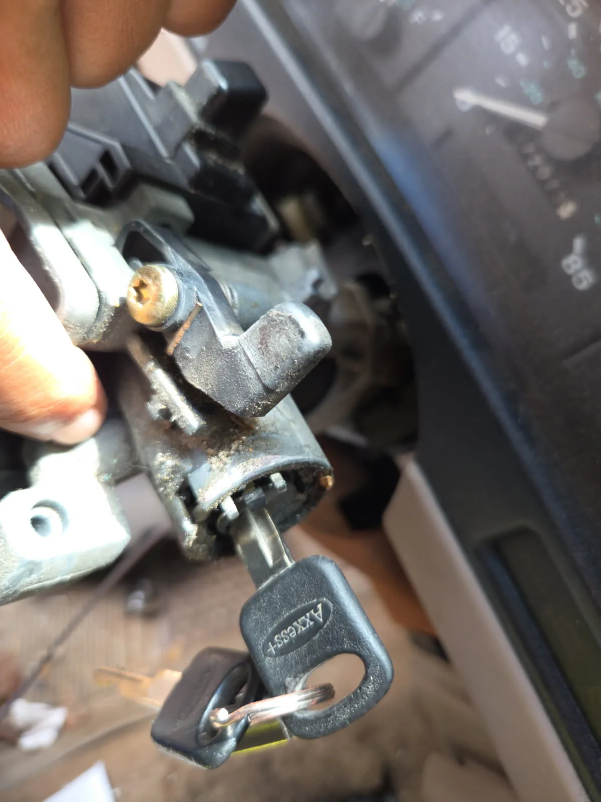 Close-up of an automotive lock cylinder being serviced