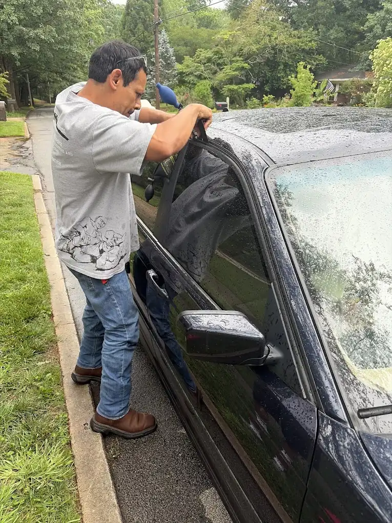 Locksmith opening a vehicle door on-site
